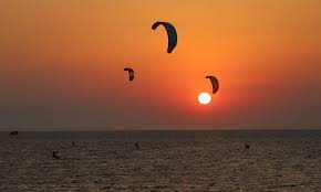 Kiteboarder mid-air over breaking waves at Cape Hatteras National Seashore on the Outer Banks
