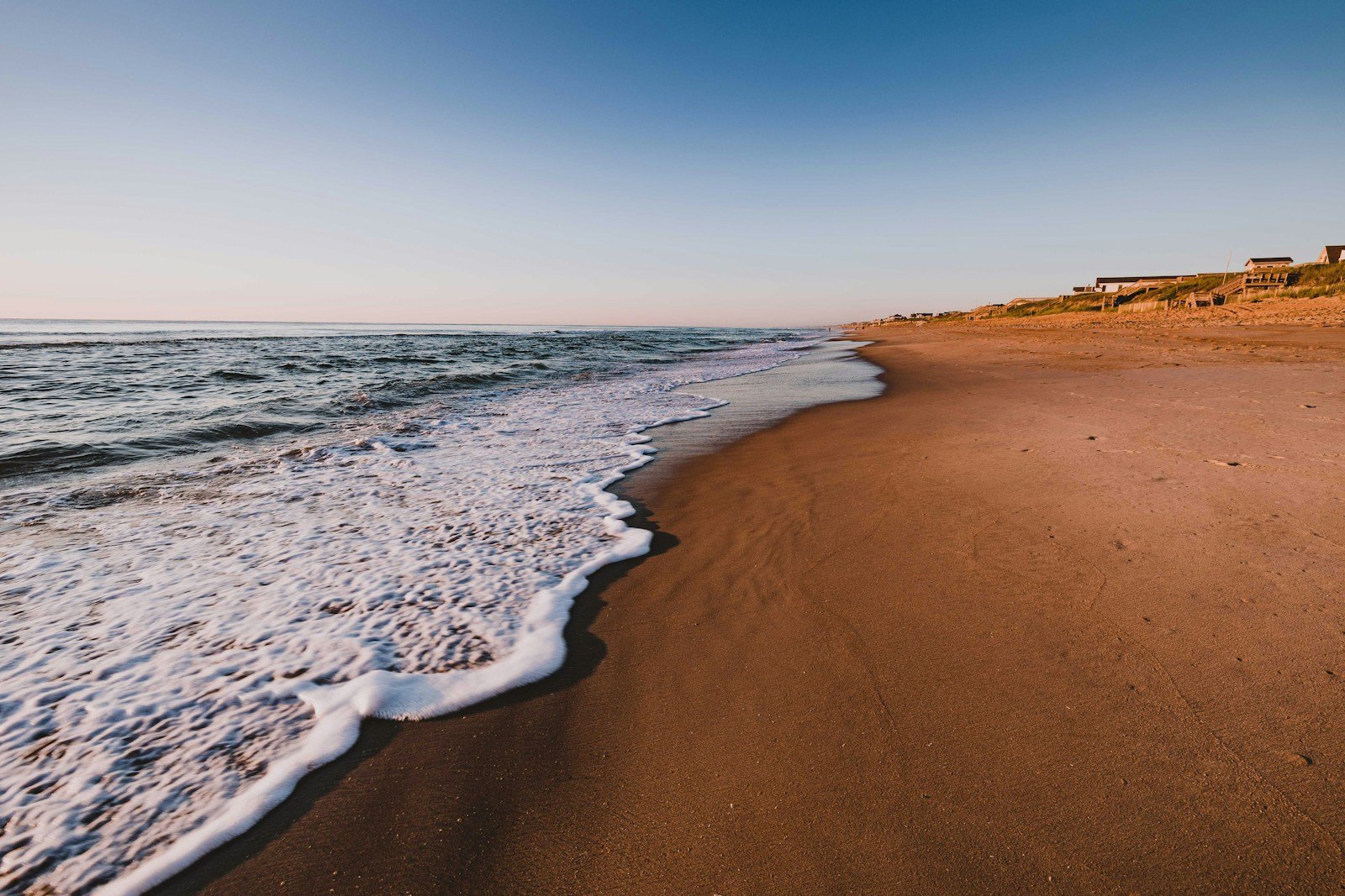 Atlantic waves crashing on the Outer Banks shoreline during daytime