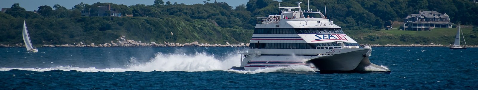White and black ferry ship on the open sea during daytime