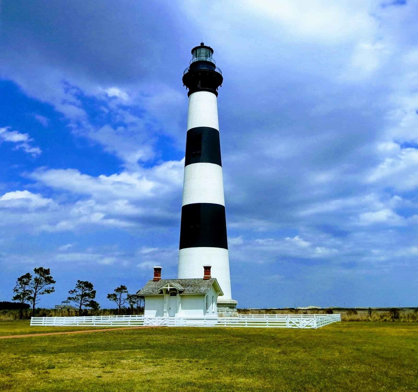 Cape Hatteras Lighthouse with its iconic black-and-white spiral pattern under a blue sky