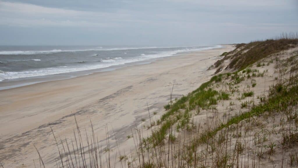 Waves rolling in on a wide, empty stretch of beach near Ramp 25.