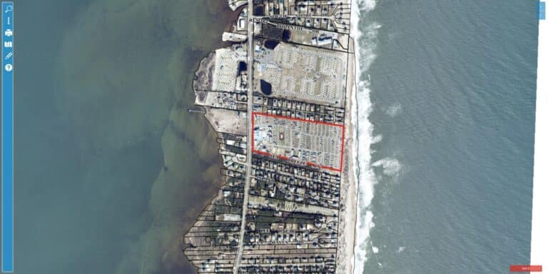 Aerial view of Cape Hatteras KOA Resort at 25099 NC Highway 12 in Waves NC, showing oceanfront RV sites on a barrier island between Pamlico Sound and the Atlantic Ocean