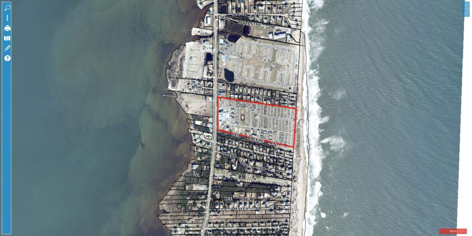 Aerial view of Cape Hatteras KOA Resort at 25099 NC Highway 12 in Waves NC, showing oceanfront RV sites on a barrier island between Pamlico Sound and the Atlantic Ocean