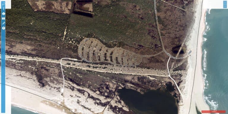 Aerial view of Cape Point Campground, a National Park Service campground near Cape Hatteras Lighthouse in Buxton NC, with camping loops set among dunes near the Atlantic Ocean at Cape Point