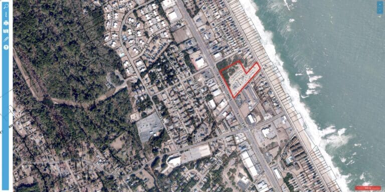 Aerial view of Kitty Hawk RV Park at 3945 N Croatan Highway, Kitty Hawk NC, showing RV sites between the neighborhood and the Atlantic Ocean beachfront