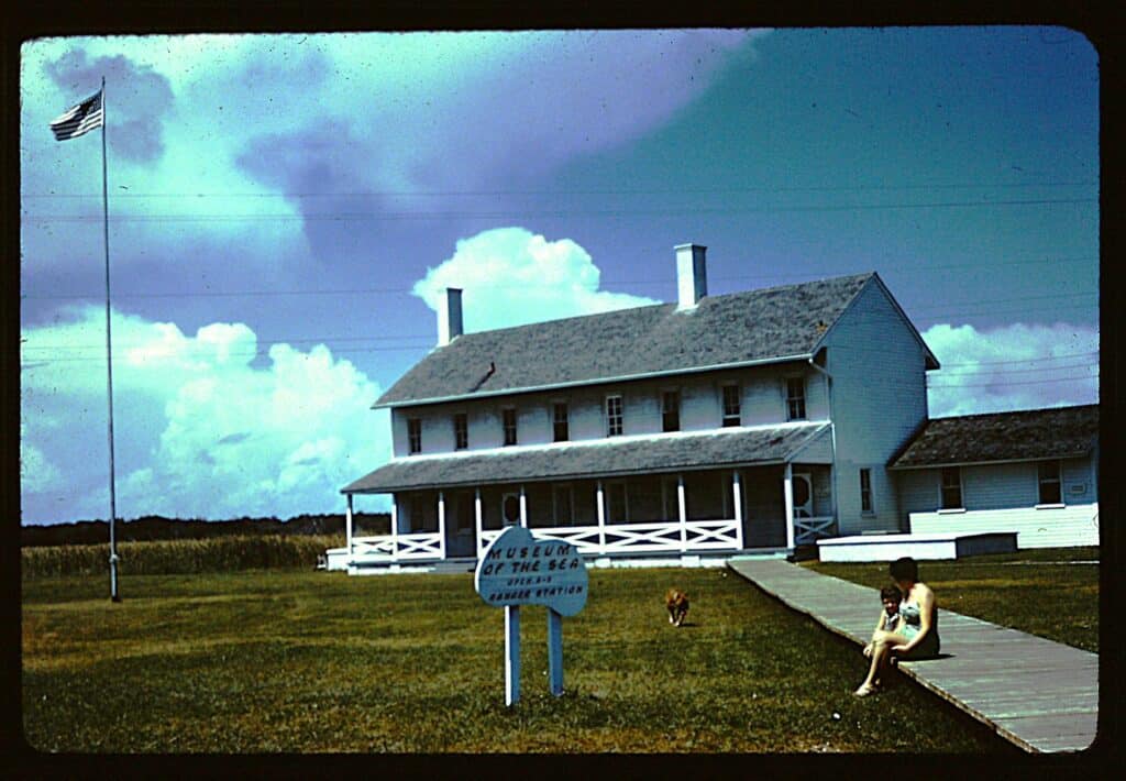 An older photograph of the teal-painted Museum of the Sea building in the Cape Hatteras lighthouse complex.