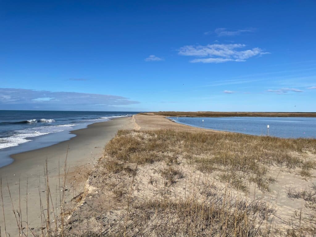 Wide, water-scoured sand where the salt pond drained across the beach after a March wind storm.